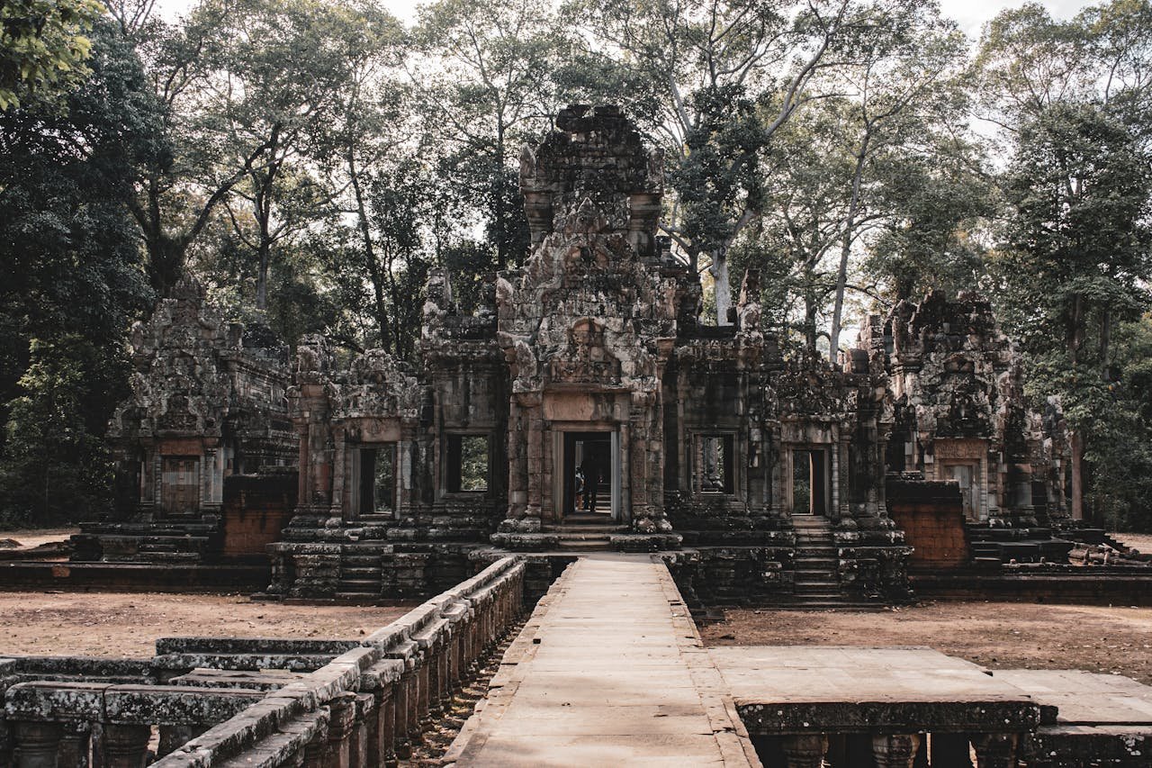 Explore the serene beauty of an ancient Cambodian temple set amidst lush greenery in Siem Reap.